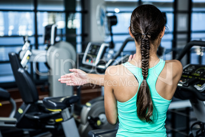 Rear view of woman stretching arms