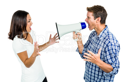 Couple shouting with man holding megaphone