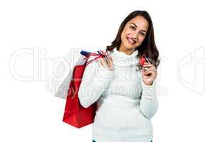 Portrait of happy woman with shopping bags and payment card
