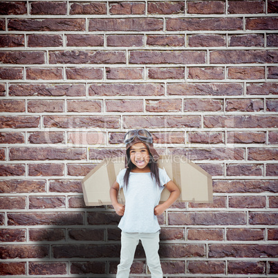 Composite image of standing girl with fake wings pretending to b