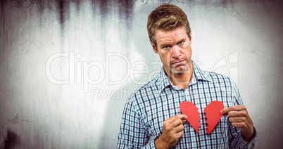 Composite image of sad man with broken heart