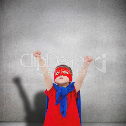 Composite image of masked boy pretending to be superhero