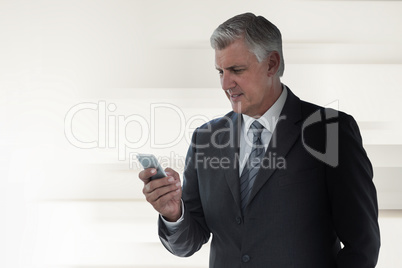 Composite image of businessman using his smartphone