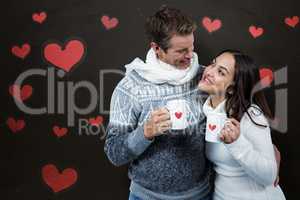 Composite image of festive couple smiling and holding mugs