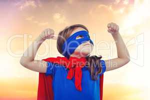 Composite image of masked girl pretending to be superhero