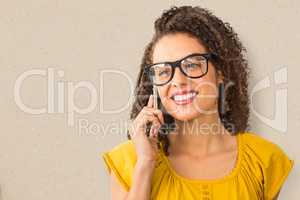 Composite image of businesswoman wearing glasses while using mob