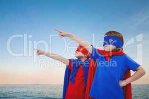 Composite image of masked kids pretending to be superheroes