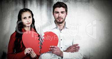 Composite image of couple holding heart halves