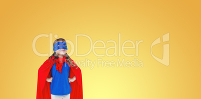 Composite image of masked girl pretending to be superhero