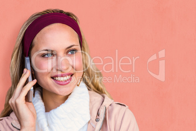 Composite image of smiling woman phoning with smartphone