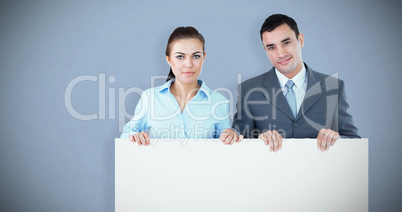 Composite image of business partners holding sign