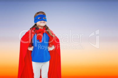 Composite image of masked girl pretending to be superhero