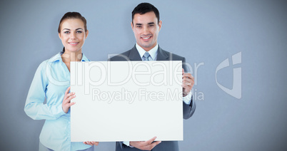 Composite image of business partners presenting sign