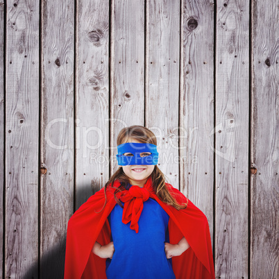 Composite image of masked girl pretending to be superhero