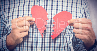 Composite image of sad man with broken heart