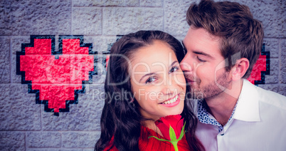 Composite image of smiling couple holding rose