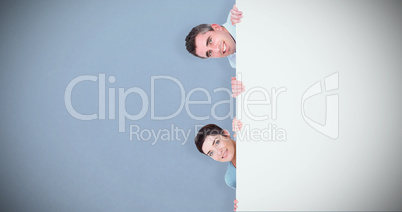 Composite image of woman and man hiding behind a blank panel