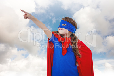 Composite image of masked girl pretending to be superhero