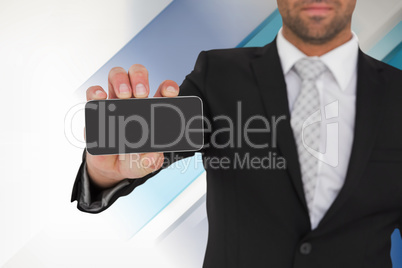 Composite image of businessman showing his smartphone screen