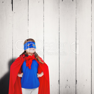 Composite image of masked girl pretending to be superhero