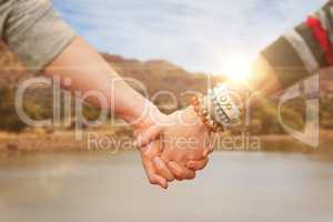 Composite image of students holding hands