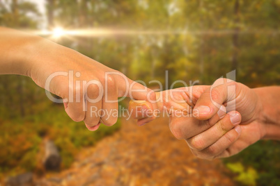 Composite image of cropped image of people holding fingers