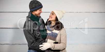 Composite image of winter couple enjoying hot drinks