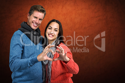 Composite image of portrait of couple making heart shape with ha