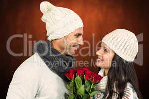 Composite image of smiling couple holding roses bouquet