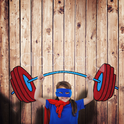 Composite image of little girl holding dumbbell