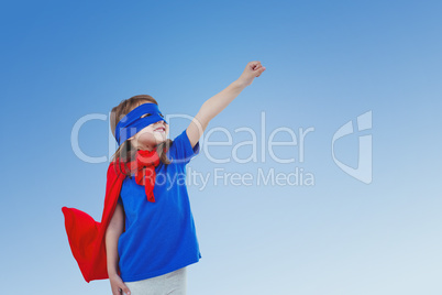 Composite image of masked girl pretending to be superhero