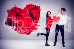 Composite image of smiling couple with sunglasses holding paper