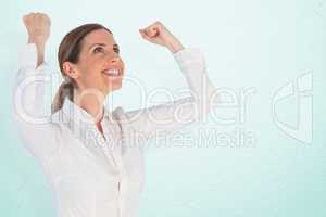 Composite image of successful businesswoman with clenched fists