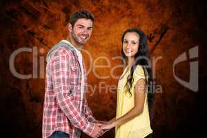 Composite image of smiling couple holding their hands and lookin