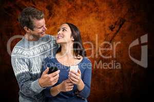 Composite image of happy romantic couple with mobile phone