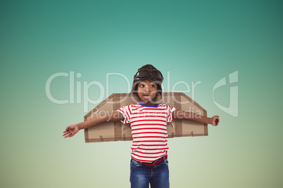 Composite image of smiling boy pretending to be pilot