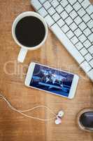 Composite image of coffee and white smartphone with headphones