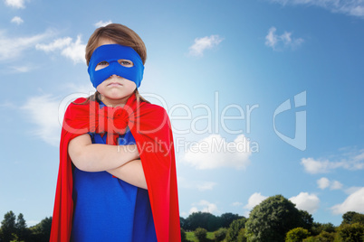 Composite image of masked girl pretending to be superhero