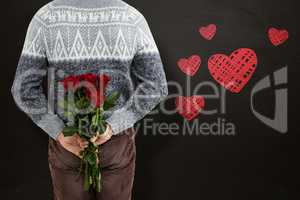 Composite image of mid section of man hiding red roses