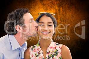 Composite image of man kissing woman on the cheek
