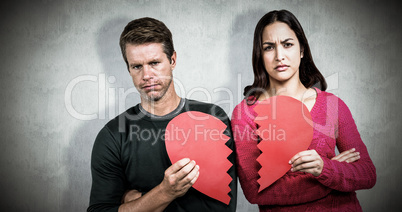 Composite image of portrait of serious couple holding cracked he