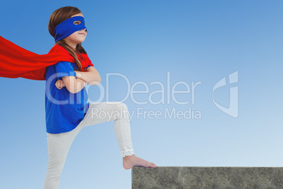 Composite image of masked girl pretending to be superhero