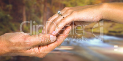 Composite image of cropped hand of couple holding hands