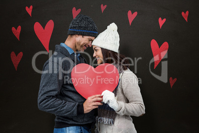 Composite image of festive couple in winter clothes