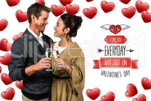 Composite image of happy romantic couple with champagne flute