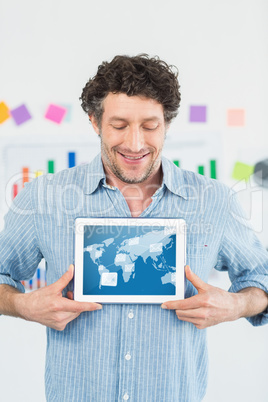 Composite image of smiling businessman showing digital tablet in