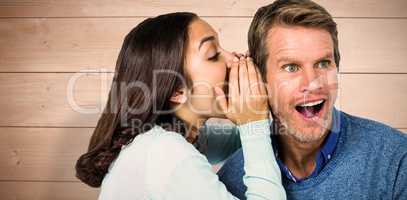 Composite image of woman whispering secret with man