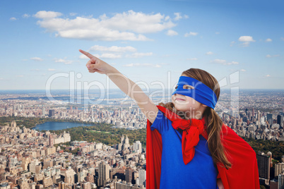 Composite image of masked girl pretending to be superhero