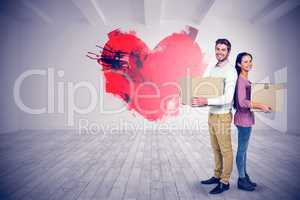 Composite image of smiling couple holding boxes