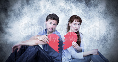 Composite image of couple holding a broken heart